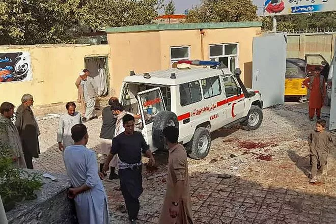 afghan men stand next to an ambulance after a bomb attack at a mosque in kunduz on october 8 2021 photo afp afghan men stand next to an ambulance after a bomb attack at a mosque in kunduz on october 8 2021 photo afp