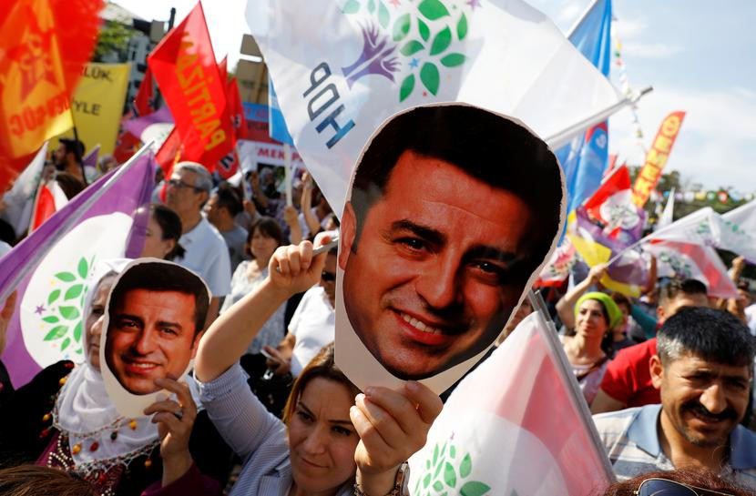 a supporter of turkey s main pro kurdish peoples democratic party hdp holds a mask of their jailed former leader and presidential candidate selahattin demirtas during a rally in ankara turkey june 19 2018 photo reuters file