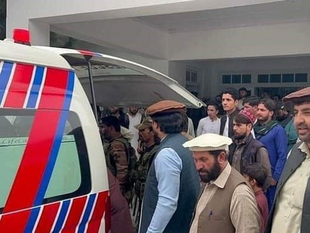 a crowd gathers around an ambulance transporting an injured victim to the hospital photo express