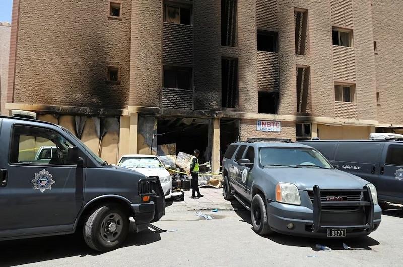 a kuwaiti police officer is seen in front of a burnt building following a deadly fire in mangaf southern kuwait june 12 2024 photo reuters