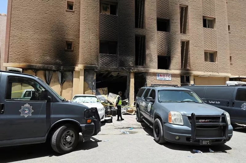 a kuwaiti police officer is seen in front of a burnt building following a deadly fire in mangaf southern kuwait june 12 2024 photo reuters a kuwaiti police officer is seen in front of a burnt building following a deadly fire in mangaf southern kuwait june 12 2024 photo reuters