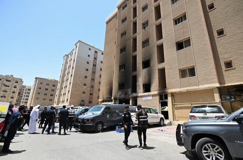kuwaiti police officers are seen in front of a burnt building following a deadly fire in mangaf southern kuwait june 12 2024 photo reuters