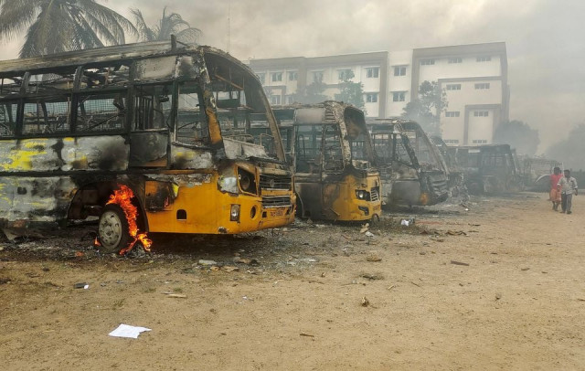 people walk past damaged school buses that were set on fire by a mob in the school campus after a female student s death in kallakurichi district in the southern state of tamil nadu india july 17 2022 photo reuters people walk past damaged school buses that were set on fire by a mob in the school campus after a female student s death in kallakurichi district in the southern state of tamil nadu india july 17 2022 photo reuters