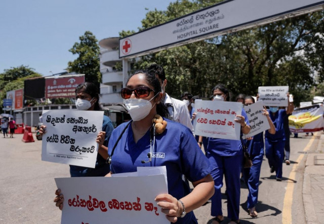 government medical officers association members walk with placards protesting against sri lankan president gotabaya rajapaksa after his government lost its majority in parliament during a demonstration near the parliament building in colombo sri lanka april 6 2022 reuters government medical officers association members walk with placards protesting against sri lankan president gotabaya rajapaksa after his government lost its majority in parliament during a demonstration near the parliament building in colombo sri lanka april 6 2022 reuters