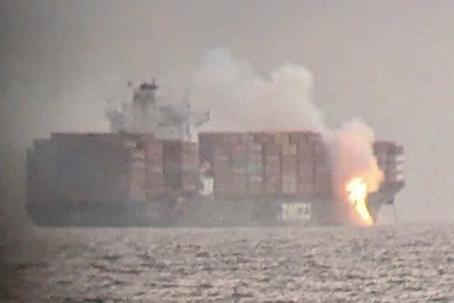 fire cascades down from the deck of the container ship zim kingston into the waters off the coast of victoria british columbia canada october 23 2021 as seen through a pair of binoculars in this image obtained via social media photo reuters fire cascades down from the deck of the container ship zim kingston into the waters off the coast of victoria british columbia canada october 23 2021 as seen through a pair of binoculars in this image obtained via social media photo reuters