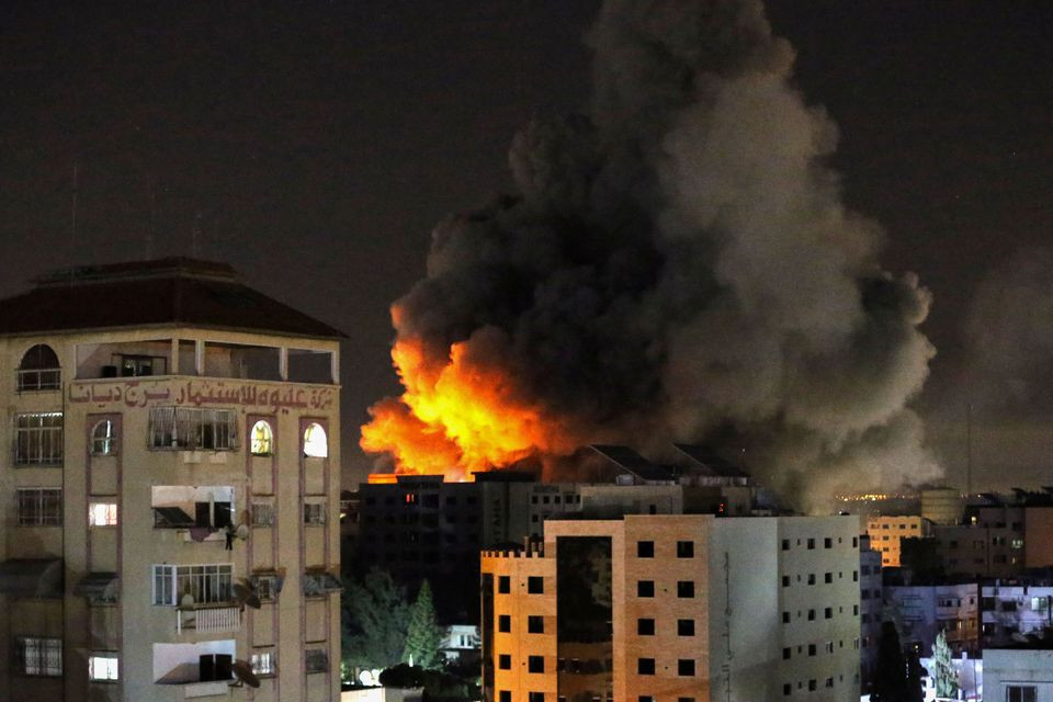 Smoke rises from a tower after it was hit by Israeli air strikes amid a flare-up of Israeli-Palestinian violence, in Gaza City May 12, 2021. PHOTO: REUTERS