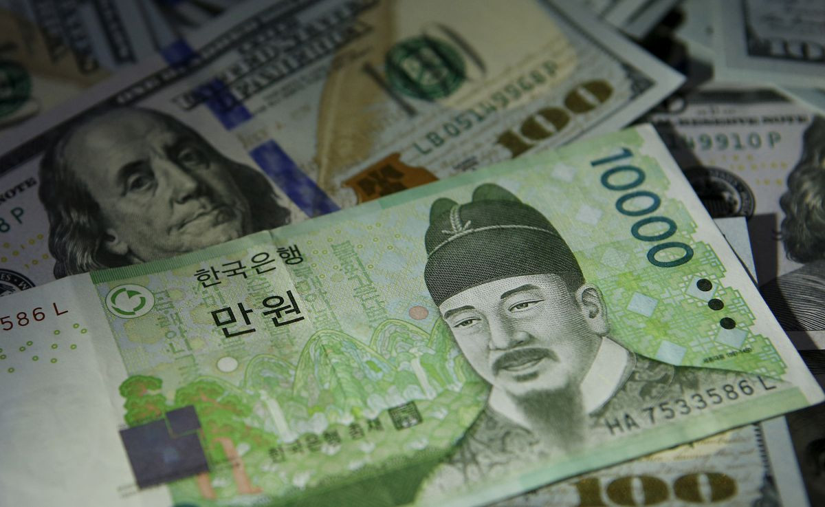 south korean 10 000 won note is seen on u s 100 dollar notes in this picture illustration taken in seoul south korea december 15 2015 reuters