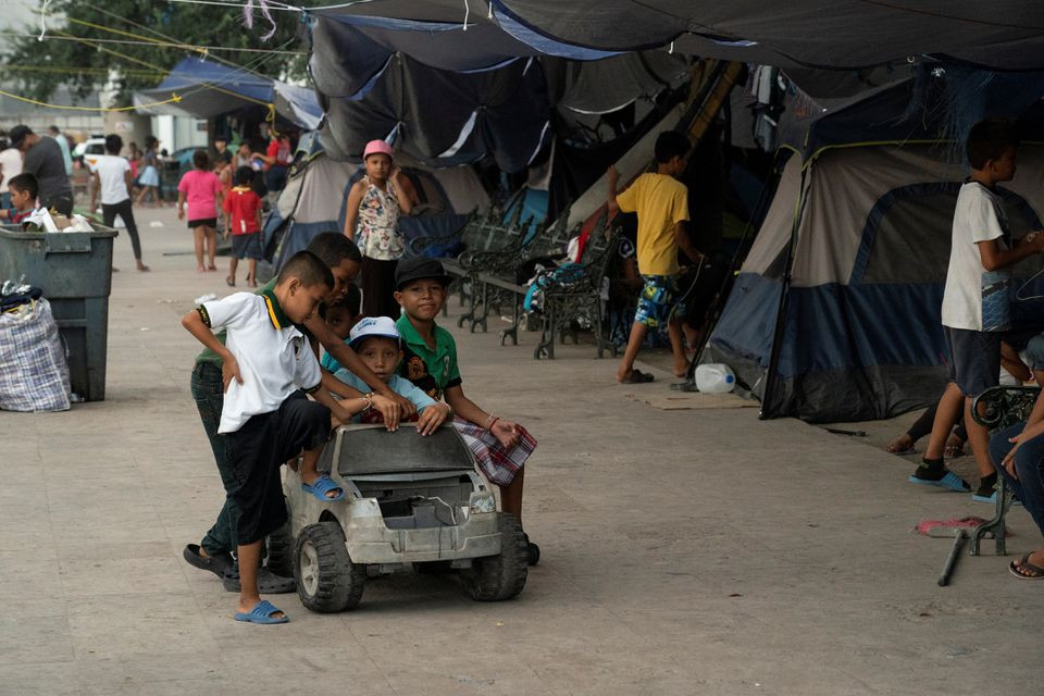 asylum seeking migrant children from central america who were sent back to mexico under title 42 after crossing the border into the us from mexico play with a toy car in the public square where hundreds of migrants live in tents in reynosa mexico august 27 2021 photo reuters file