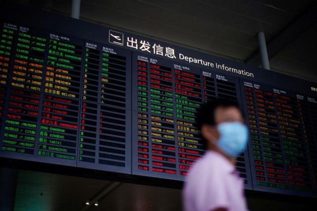 a man wearing a face mask is seen at hongqiao international airport in shanghai following the coronavirus disease covid 19 outbreak china may 21 2020 photo reuters a man wearing a face mask is seen at hongqiao international airport in shanghai following the coronavirus disease covid 19 outbreak china may 21 2020 photo reuters