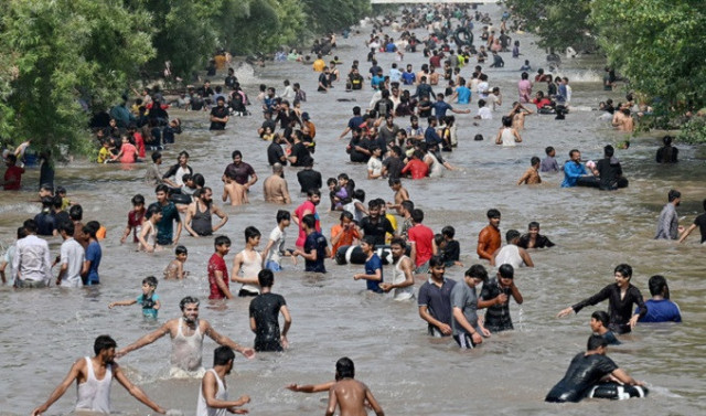 people take a dip in a canal to cool off on a hot summer afternoon in lahore on may 19 2024 photo afp people take a dip in a canal to cool off on a hot summer afternoon in lahore on may 19 2024 photo afp