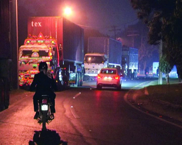 container mounted trucks move along a road in lahore the punjab government has ordered containers to block roads in order to prevent pti supporters from reaching islamabad photo asad mehmood express