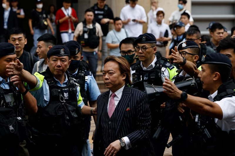 Lawrence Lau Wai-chung is escorted by police outside the West Kowloon Magistrates' Courts building after being acquitted of charges under the national security law, in Hong Kong, China, May 30, 2024. PHOTO: REUTERS