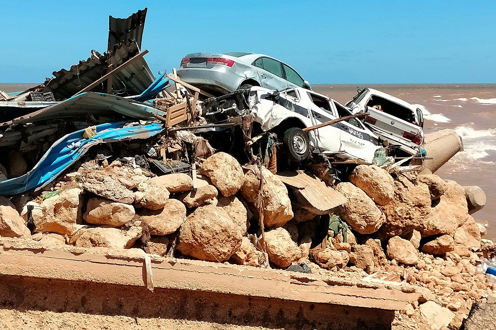 Cars are piled up atop the rubble of a building destroyed in flash in Derna on September 13, 2023. PHOTO: AFP