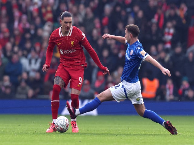 accrington stanley s william crellin and donald love in action with liverpool s diogo jota at anfield liverpool on january 11 2025 photo reuters