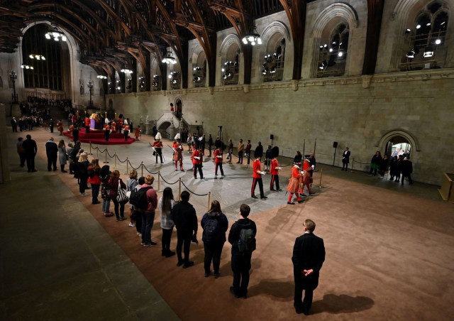 the guard is changed while public pays their respect as they pass the coffin of queen elizabeth ii as it lies in state inside westminster hall photo reuters the guard is changed while public pays their respect as they pass the coffin of queen elizabeth ii as it lies in state inside westminster hall photo reuters