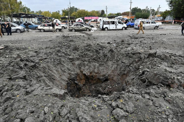 a crater left by a russian missile strike that hit a convoy of civilian vehicles amid russia s attack on ukraine photo reuters a crater left by a russian missile strike that hit a convoy of civilian vehicles amid russia s attack on ukraine photo reuters