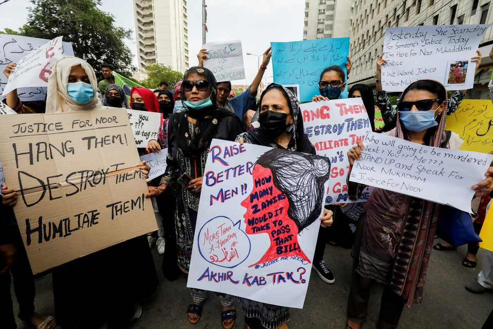 people carry signs against the killing of noor mukadam 27 daughter of former pakistani diplomat and to condemn the violence against women and girls during a protest in karachi pakistan july 25 2021 reuters