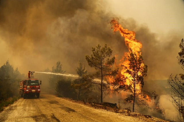 a firefighter extinguishes a forest fire near the town of manavgat east of the resort city of antalya turkey photo reuters