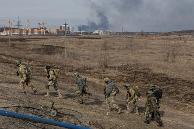 ukrainian servicemen walk near a destroyed bridge as russia s invasion of ukraine continues in the town of irpin outside kyiv ukraine march 12 2022 photo reuters ukrainian servicemen walk near a destroyed bridge as russia s invasion of ukraine continues in the town of irpin outside kyiv ukraine march 12 2022 photo reuters