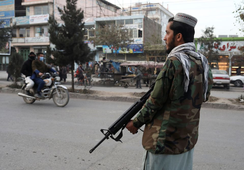 a taliban fighter stands guard at the site of a blast in kabul photo reuters file