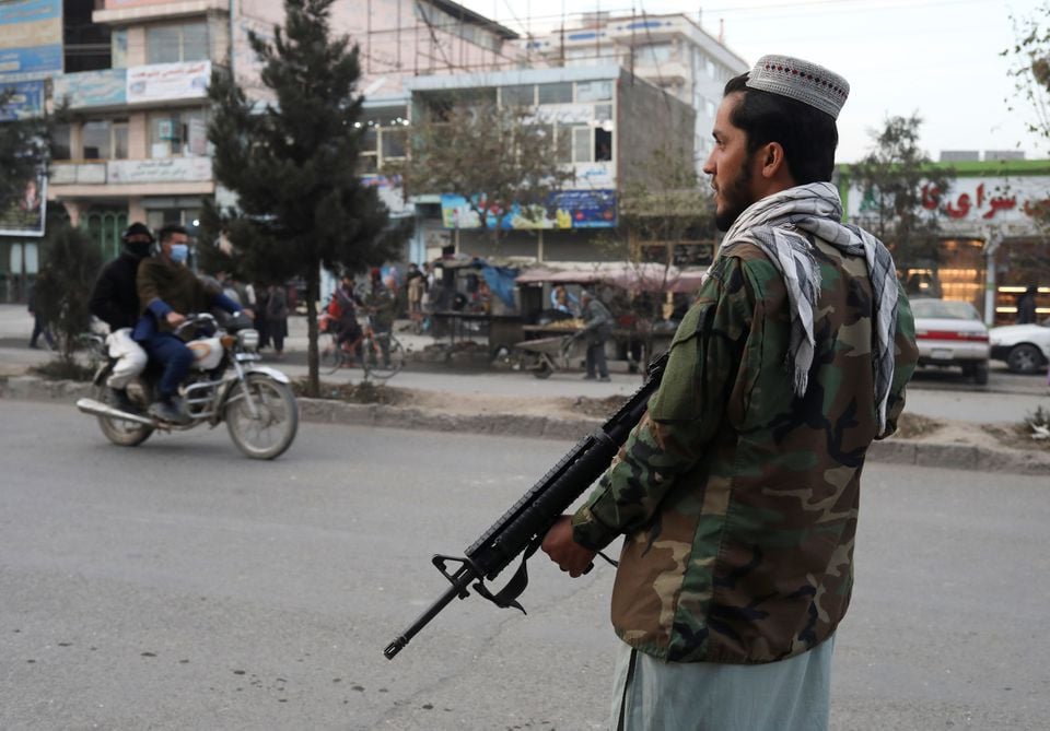 a taliban fighter stands guard at the site of a blast in kabul photo reuters file