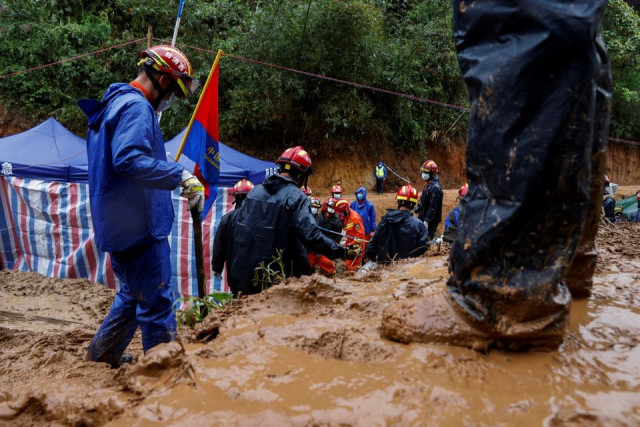 rescue workers work at the site where a china eastern airlines boeing 737 800 plane flying from kunming to guangzhou crashed in wuzhou guangxi zhuang autonomous region china march 24 2022 reuters