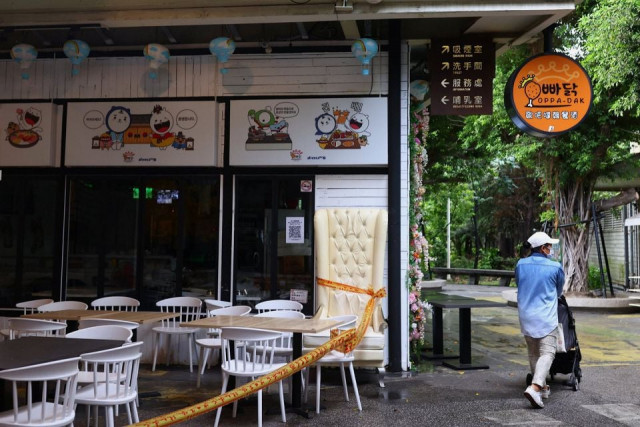 a woman wearing a protective face mask pushes a stroller past a closed restaurant following the recent rise in coronavirus disease covid 19 infections in taipei taiwan photo reuters a woman wearing a protective face mask pushes a stroller past a closed restaurant following the recent rise in coronavirus disease covid 19 infections in taipei taiwan photo reuters