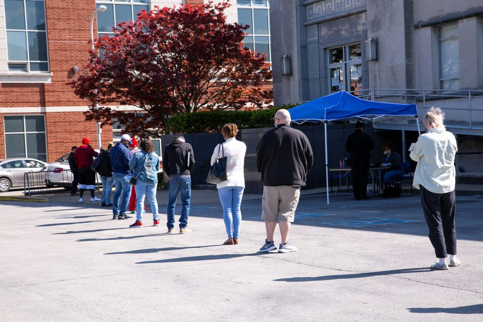 people wait in a line outside a newly reopened career center for in person appointments in louisville kentucky u s april 15 2021 reuters