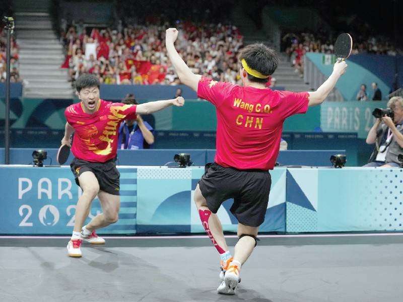 ma long wins a point in the men s team final in paris photo afp