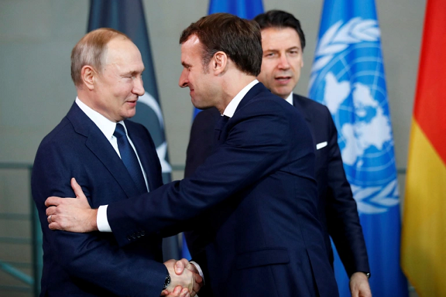 russian president vladimir putin shakes hands with french president emmanuel macron during the libya summit in berlin germany january 19 2020 photo reuters