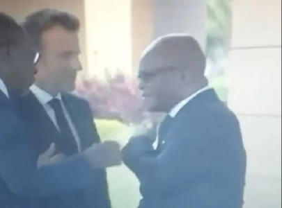 video shows benin fm cleaning shoulder after being touched by macron