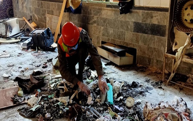 rescue worker examines the site of the explosion photo afp