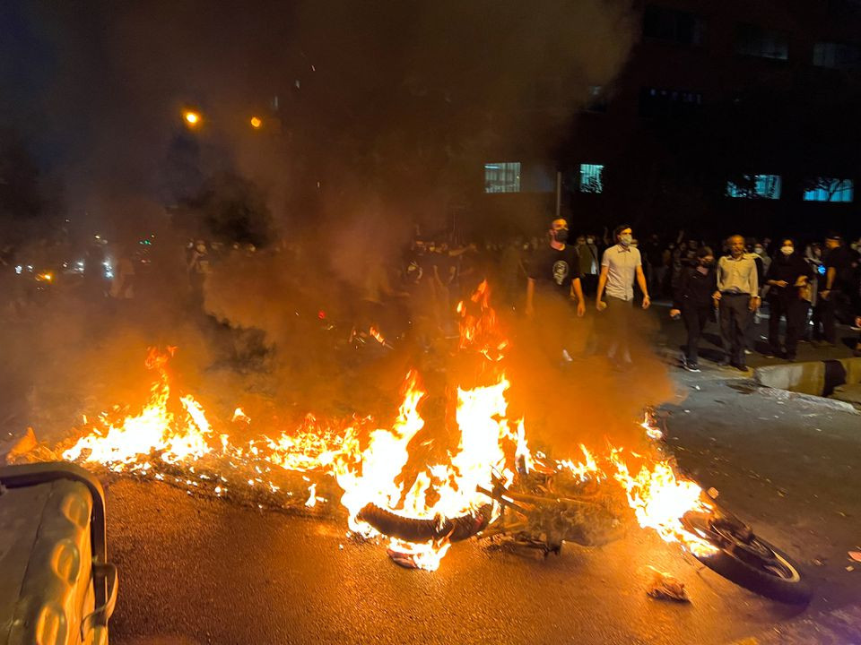 a police motorcycle burns during a protest over the death of mahsa amini a woman who died after being arrested by the islamic republic s morality police in tehran iran september 19 2022 photo reuters file