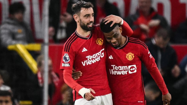 hanging on manchester united s amad diallo r celebrates with bruno fernandes photo afp hanging on manchester united s amad diallo r celebrates with bruno fernandes photo afp