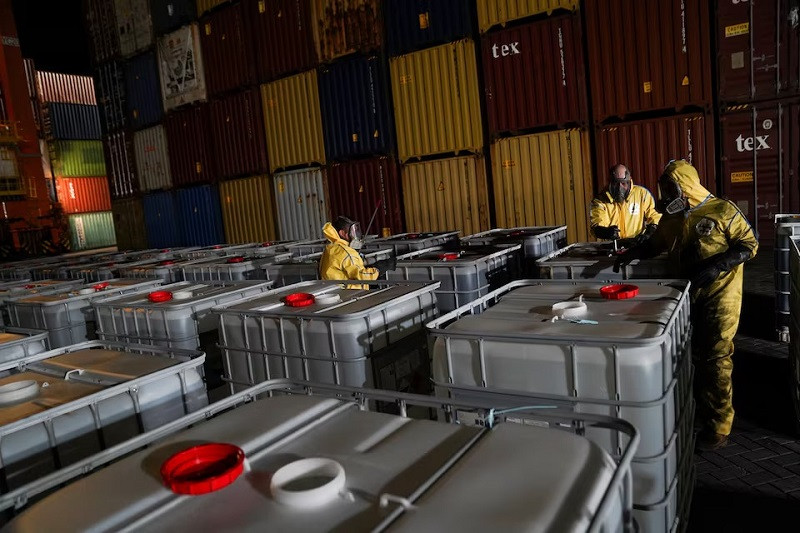 Employees of a private company in full protective gear open a bulk liquid container with glacial acetic acid made in China while checking a shipment, at Manzanillo port, in Manzanillo, Colima, Mexico July 4, 2024. PHOTO: REUTERS