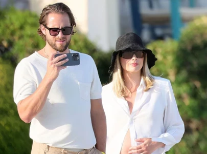 margot robbie radiates pregnancy glow during stylish lunch date in sardinia