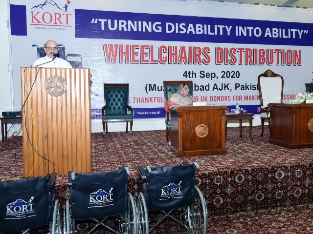 ajk president masood khan addressing a function organised by kashmir orphan relief trust kort on friday to distribute wheelchairs among 110 disabled people photo express