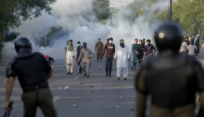 protestors throw stones after police fire tear gas to disperse them in lahore on may 9 2023 photo reuters