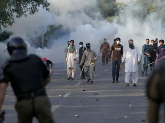 protestors throw stones after police fire tear gas to disperse them in lahore on may 9 2023 photo reuters