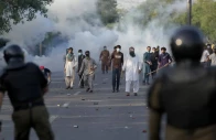 supporters of pakistan tehreek e insaf pti throw stones after police fire tear gas to disperse them in lahore on may 9 2023 photo reuters file