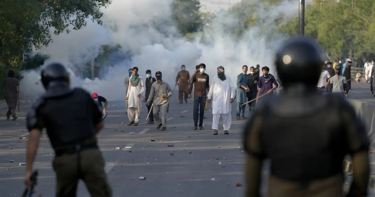 supporters of pakistan tehreek e insaf pti throw stones after police fire tear gas to disperse them in lahore on may 9 2023 photo reuters file