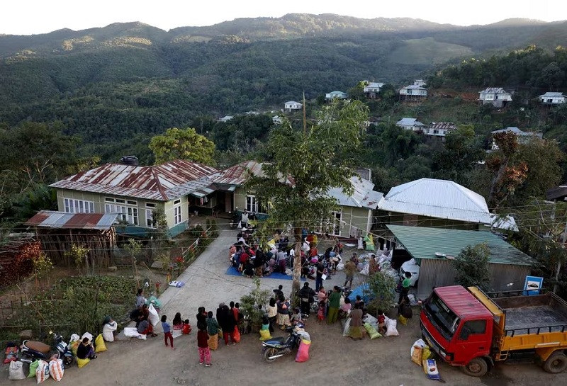 people who fled from myanmar collect donated clothes at a temporary distribution centre at farkawn village near the india myanmar border mizoram india november 20 2021 photo reuters