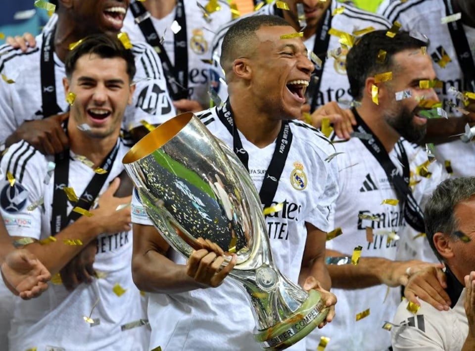 real madrid s kylian mbappe celebrates with the trophy after winning the super cup against atalanta in a match played at national stadium warsaw poland on august 14 2024 photo reuters