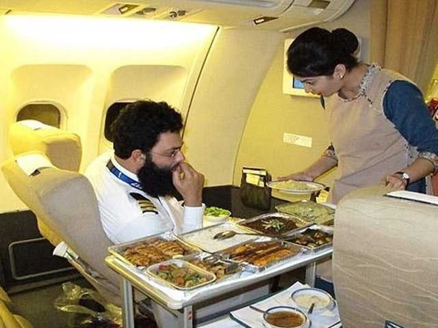 in this undated photo a pakistan international airline pia crew member serves meal inside an aircraft of the national flag carrier photo file