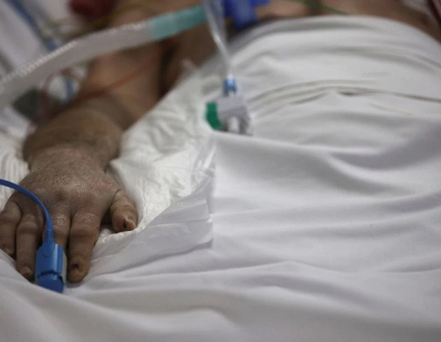 a pulse oximeter is placed on the hand of a patient photo reuters