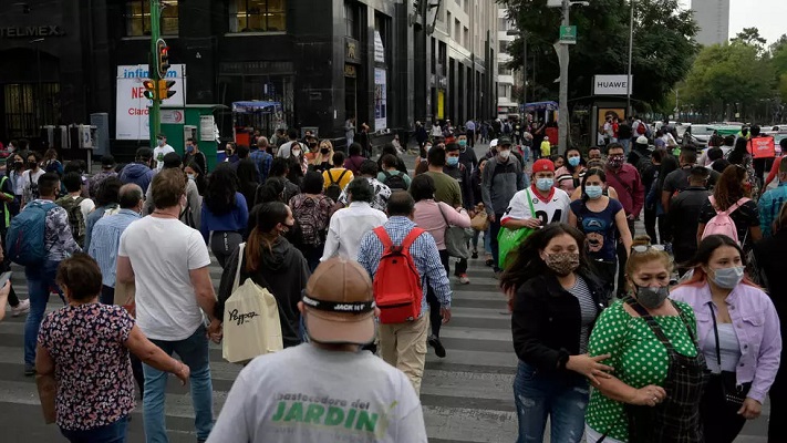 people walk in downtown mexico city on december 16 2020 amid the covid 19 pandemic photo afp