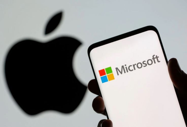 microsoft logo is seen on the smartphone in front of displayed apple logo in this illustration taken july 26 2021 photo reuters file