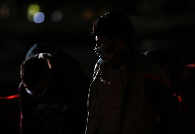 migrants wait to disembark from a spanish coast guard vessel in the port of arguineguin in the island of gran canaria spain november 14 2021 photo reuters