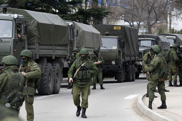 armed servicemen wait near russian army vehicles outside a ukrainian border guard post in the crimean town of balaclava march 1 2014 photo reuters