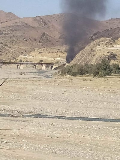 smoke rises in the distance from a security forces vehicle after the suicide attack photo express